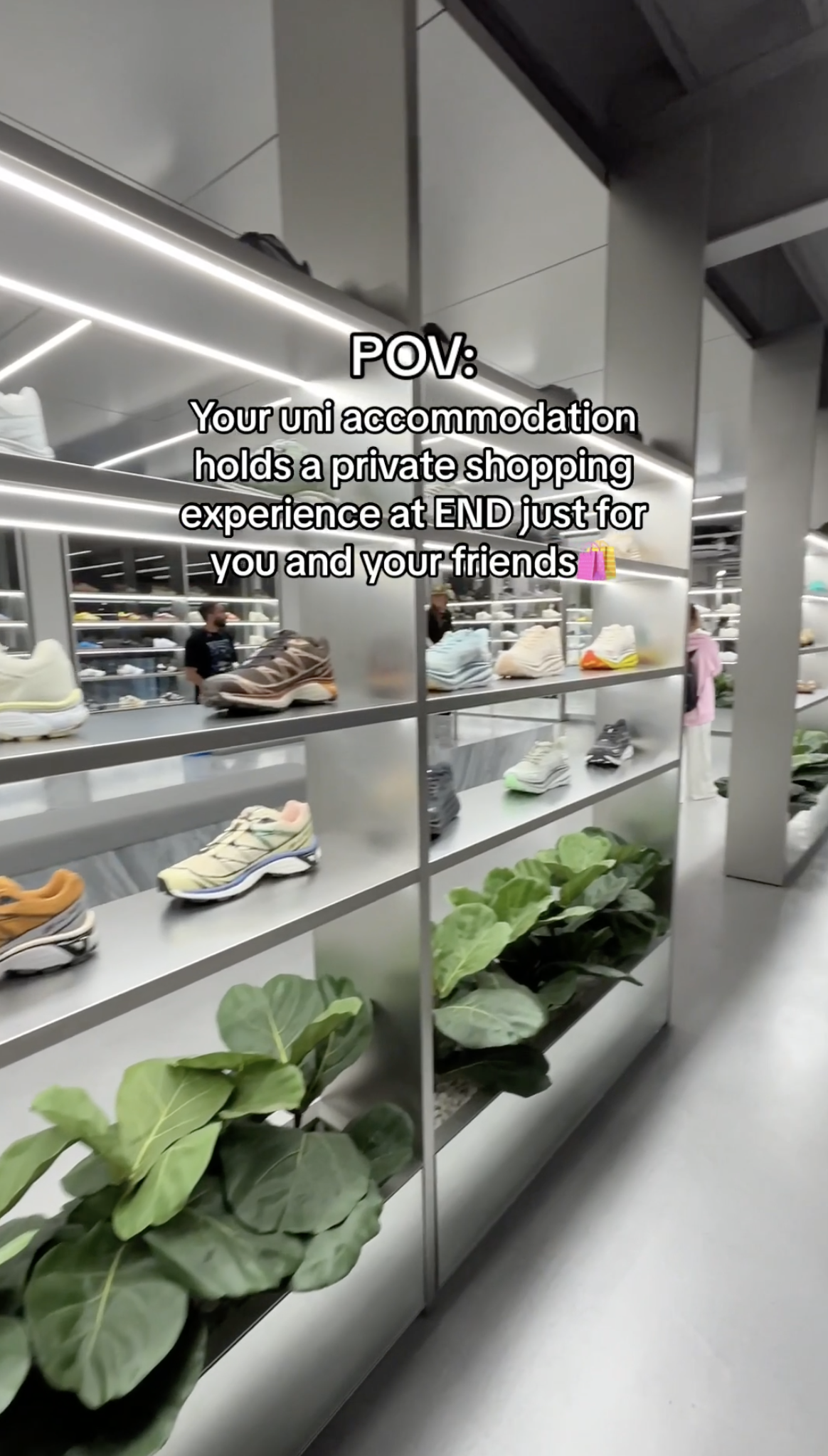 A shoe store with a variety of sneakers displayed on shelves. Text reads, "POV: Your uni accommodation holds a private shopping experience at END just for you and your friends." The floor is gray, and there are plants on lower shelves.
